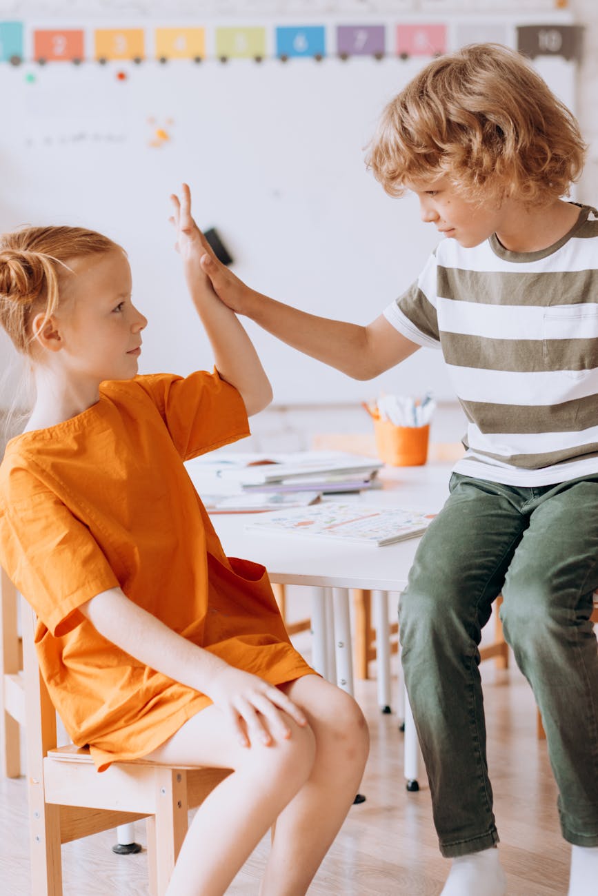 a boy and a girl doing high five