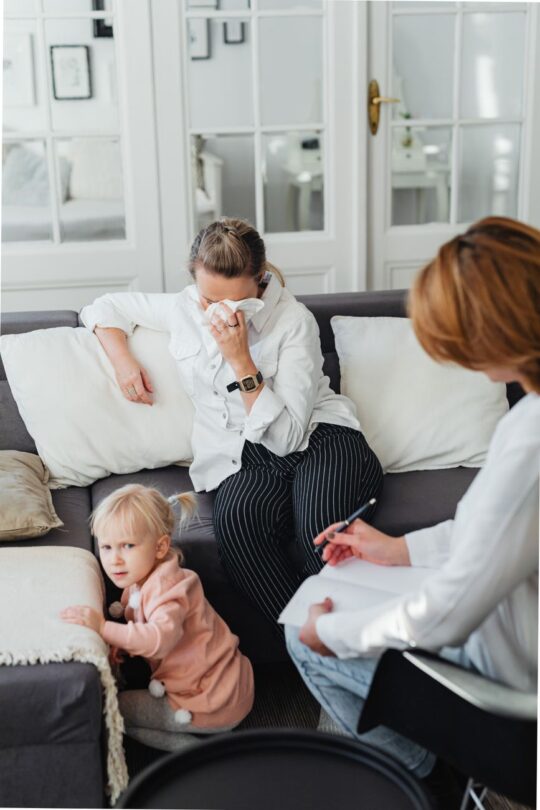crying woman on sofa and child